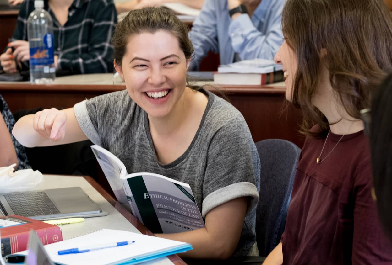 two students laughing in classroom