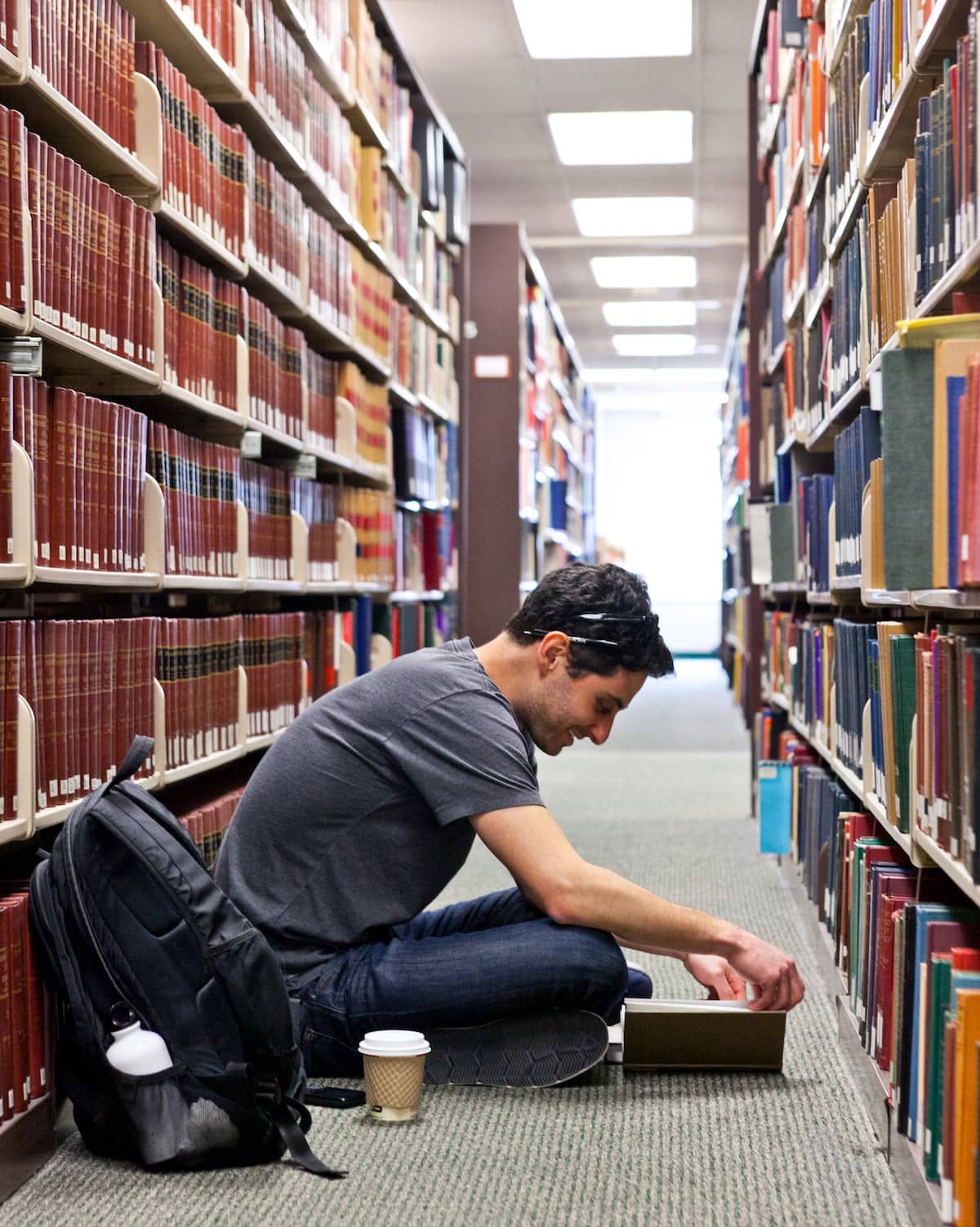 Two students play a piano in one of the common areas